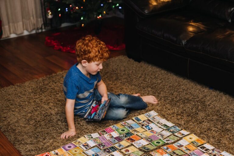 A little boy playing Pokémon cards
